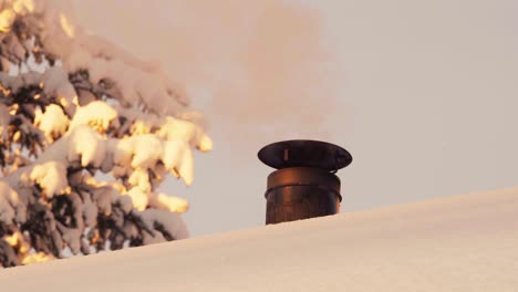 White-Smoke-Coming-Out-On-Chimney-On-Snowy-Roof-During-Winter