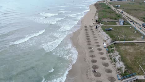 Foamy-Waves-Crashing-On-The-Shore-In-Vama-Veche-Beach,-Romania---aerial-drone-shot