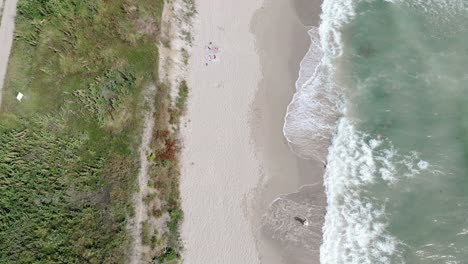 Flying-Over-Sandy-Beach-In-Vama-Veche,-Romania---drone-shot