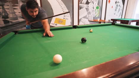 Casual-player-pocketing-the-8-ball-winning-the-american-style-eight-ball-game-in-slow-motion