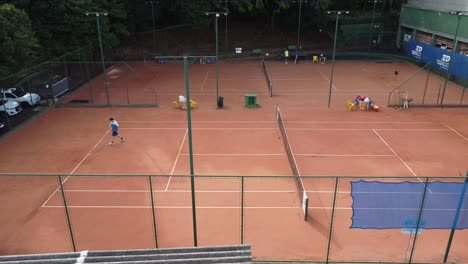 Lateral-drone-shot-of-a-tennis-practice-at-the-Ribeirão-Tennis-Academy