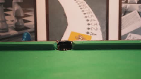 Snooker-billiard-table-shot-sinking-green-six-ball-with-white-cue-ball