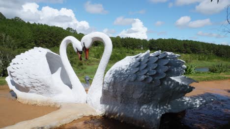 Clay-sculpture-of-two-swans-with-their-necks-curved-into-the-shape-of-a-heart