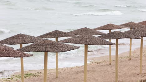 Tranquil-Landscape-With-Rattan-Sunshades-And-Ocean-Waves---static