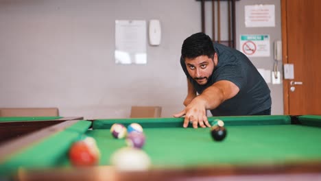 Young-man-playing-billiard-snooker-player-missing-the-shot