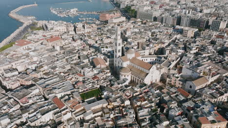 Aerial-footage-flying-towards-a-church-spire-that's-in-the-middle-of-Old-City-Bari,-Italy