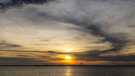 Timelapse-of-a-cloudy-sunset-over-Darwin-Harbour,-Northern-Territory-during-the-wet-season