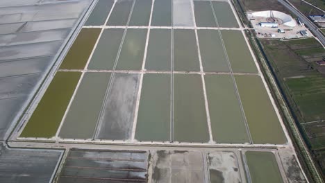 Drying-sea-salt-on-flat-pools-with-seawater-and-factory-for-packaging-the-natural-product