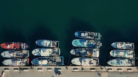 Fischerboote-Liegen-Nebeneinander-Am-Kai-Mit-Langen-Schatten-Im-Grünen-Meer