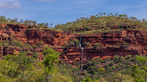 Timelapse-of-a-waterfall-as-it-is-flowing-over-a-mountain-face-in-the-Northern-Territory