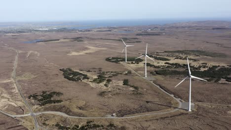 Drohnenaufnahme-Eines-Windparks-Mit-Rotierenden-Windturbinen,-Die-Grüne,-Nachhaltige-Energie-Erzeugen