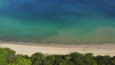 Aerial-Drone-Flyover-Nacascolo-Beach-Tropical-Scenery-And-Blue-Water-In-Costa-Rica,-4K