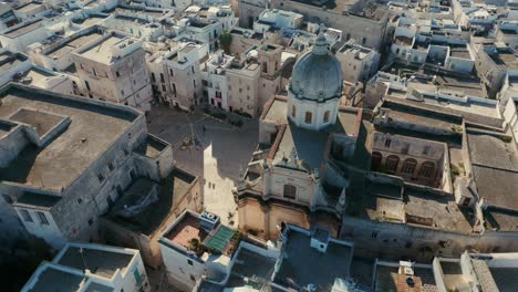 Fast-drone-panning-shot-of-the-historical-church-Santa-Teresa-in-the-Italian-city-Monopoli-on-a-sunny-day