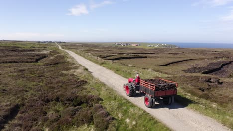 Drone-shot-following-a-tractor-full-of-peat