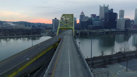 Driver-POV-exiting-Fort-Pitt-Tunnel-onto-Fort-Pitt-Bridge-revealing-beautiful-Pittsburgh,-Pennsylvania-skyline-during-sunrise