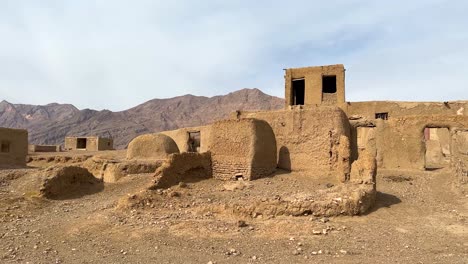 Ruins-of-desert-dwelling-settlement-central-Iran-hot-heat-warm-dry-climate-cloudy-blue-sky-sun-light-morning-traditional-mud-clay-brick-house-architecture-local-design-abandoned-rural-town-wide-view