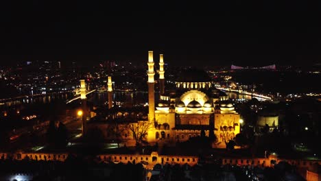 Süleymaniye-Mosque,-Lights-at-Night,-Istanbul-Turkey,-Taksim,-Rising-Up,-Timelapse,-City-Lights-at-Night-Istanbul-Turkey,-Ariel-Footage,-15th-of-July-Martyrs-Bridge