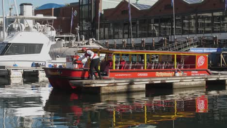 Cape-Town-harbour-tour-operator-on-dock-smiles-and-waves-at-camera