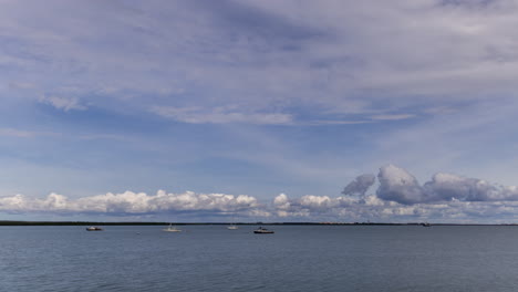 Timelapse-of-storm-clouds-building-in-Darwin-Harbour,-with-boats-anchored-during-the-wet-season
