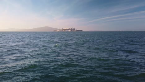 Gimbal-wide-static-shot-of-Alcatraz-Island-from-the-San-Francisco-shoreline-in-California