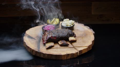 Smoky-hot-bbq-ribs-on-the-wooden-plate-with-sides-medium-shot