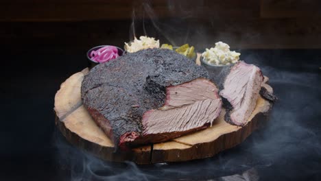 Perfectly-grilled-tasty-pork-ham-on-a-rustic-wooden-plate-with-sides-and-a-smoke-medium-tilt-up-shot