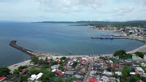 Aerial,-Rising,-Drone-View-of-Peaceful-Waterfront-Town-and-Port-in-Virac,-Catanduanes,-Philippines