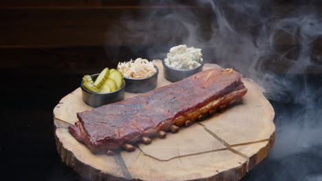 Perfectly-grilled-pork-ribs-on-a-rustic-wooden-plate-with-sides-covered-with-a-cloud-of-smoke