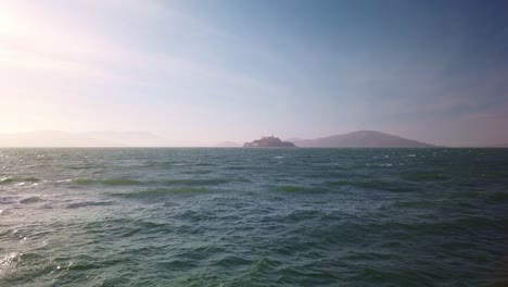Gimbal-wide-static-shot-of-Alcatraz-Island-from-the-shores-of-San-Francisco,-California