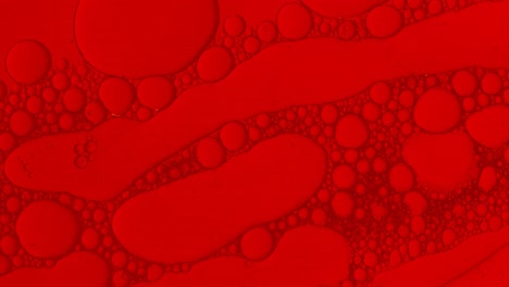 Abstrakte-Öltropfen-Hintergrund-In-Roter-Flüssigkeit-Für-Kosmetische-Behandlungen-Hydroge