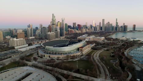 Solider-field-Arena-and-the-skyline-of-Chicago,-spring-evening-in-Illinois,-USA---circling,-drone-shot