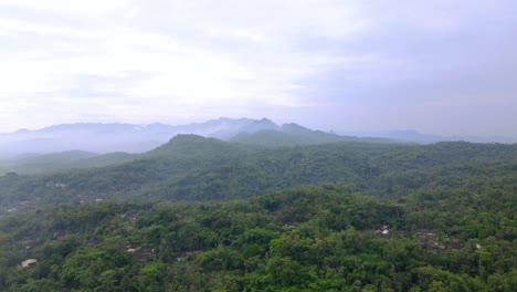 Aerial-view-of-nature-landscape-with-view-of-rain-forest-and-hill-with-cloudy-sky---Tropical-Country