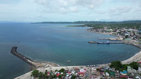 Aerial,-Rising,-Drone-View-of-Peaceful-Waterfront-Town-and-Port-in-Virac,-Catanduanes,-Philippines