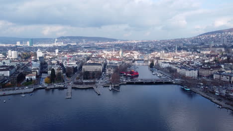 Aerial-4K-dolly-in-view-of-waterfront-Zurich-skyline-connected-by-several-bridges-at-day-time