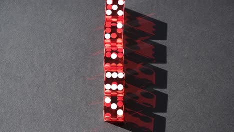 Five-red-craps-dice-in-a-row-casting-a-dark-red-rotating-shadow