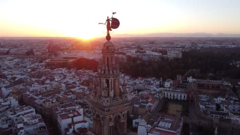 Aerial-rotation-over-the-Giraldillo,-the-sculpture-of-female-form-that-crowns-the-Giralda-of-Seville
