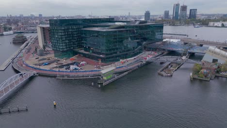 Modern-corporate-Building-next-to-the-amsterdam-canal-aerial-drone-shot