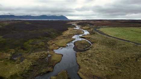 Flowing-River-in-Beautiful,-Calm-Iceland-Landscape---Wide-Aerial-Drone-View-with-Copy-Space