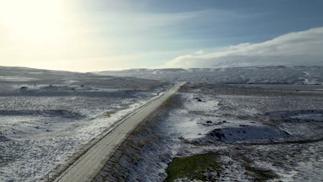 Highway-Road-in-Countryside-of-Snowy-Iceland---Aerial-Flight-with-No-People