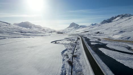 Scenic-Valley-Landscape-with-Road-in-Snowy,-Wintry-Iceland---Aerial-Flight