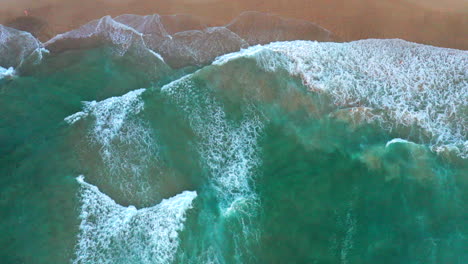 Ascending-aerial-top-down-drone-shot-of-the-beach-and-ocean-riptide-currents-at-Bondi-beach-Australia