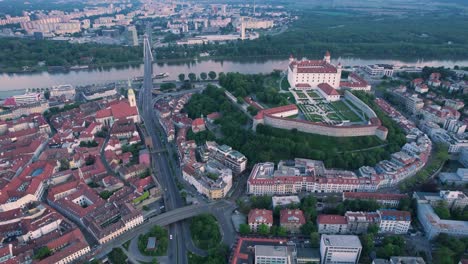 Aerial-View-of-Bratislava-Castle,-Old-Town,-Street-Traffic-and-Bridge-ABove-Danube-River