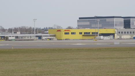 Zoom-out-shot-of-DHL-Building-at-Airport-Lecha-Wałęsy-in-Gdansk---wide-shot