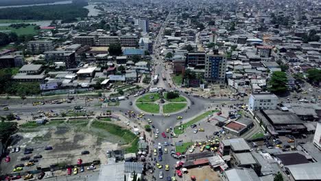 Static-aerial-view-of-traffic-at-Rond-Point-Deido-in-Douala-city,-in-sunny-Cameroon,-Africa
