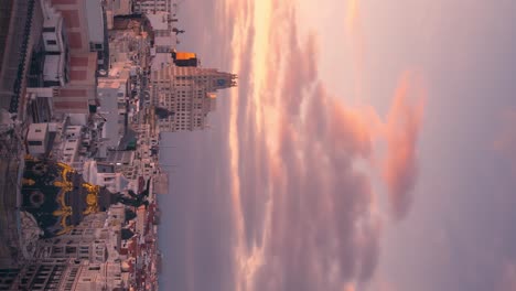 Madrid-Gran-Via-Skyline-during-cloudy-sunset-timelapse-day-to-night-vertical-smartphone-ready