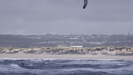 Kiteboarding-or-kitesurfing-on-rough-ocean-waves-in-Peniche,-Portugal,-one-person-view