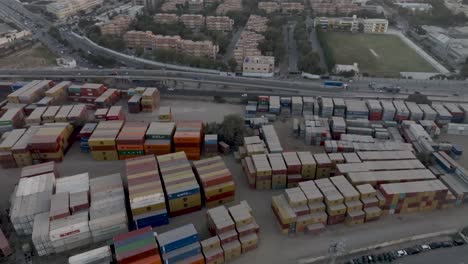 Aerial-View-Of-Dirty-Dusty-Stacked-Cargo-Containers-At-Storage-Site-In-Karachi