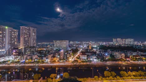 Saigon---Night-Time-Lapse-with-clouds-passing-the-moon-light-sky---High-Wide,-South-View---Vietnam,-Ho-Chi-Minh-City