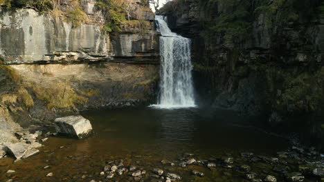 Slow-motion-waterfall-approach-in-winter-at-Ingleton-Waterfalls-Trail-Yorkshire-UK
