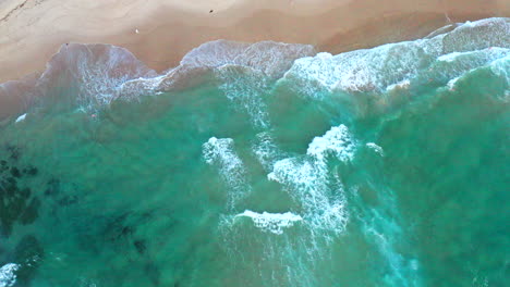 Moving-to-the-left-aerial-top-down-drone-shot-of-the-beach-and-ocean-riptide-currents-at-Bondi-beach-Australia